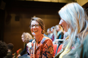 Businesswomen talking in conference audience