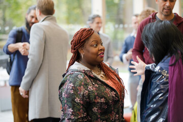 Two women greeting in hallway