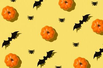 Happy Halloween concept. Overhead close up view photo of pattern of orange funny pumpkin spiders and bat isolated bright color yellow background