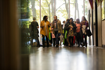 People talking in hall of auditorium