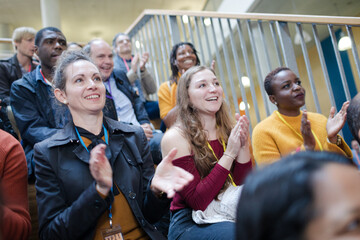 Smiling audience clapping