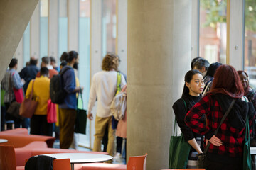 People talking in hall of auditorium