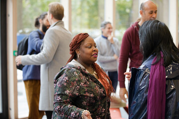Two women greeting in hallway