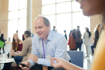 Fototapeta premium People playing cards during conference break