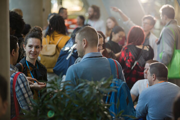 People talking in hall of auditorium