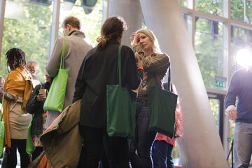 People talking in hall of auditorium