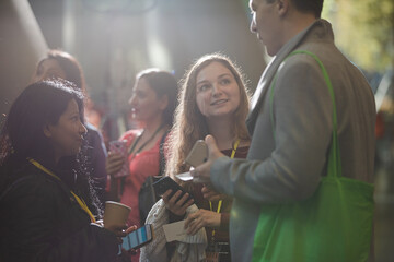 People talking in hall of auditorium