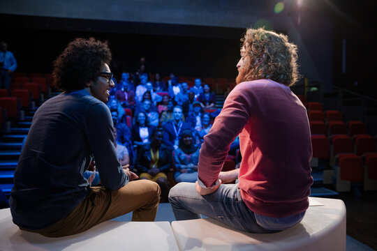 Audience watching speakers talking on stage