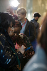 Smiling businesswomen using smart phone in conference audience