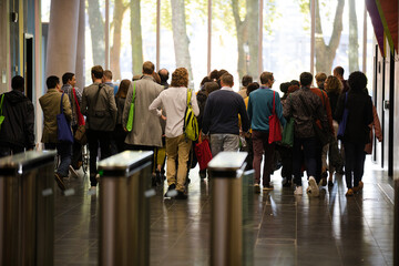 People leaving auditorium hallway