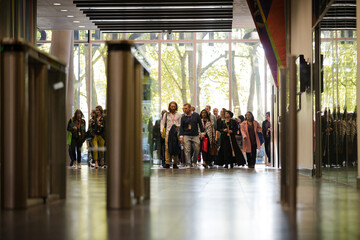 People entering auditorium hallway