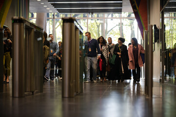 People entering auditorium hallway