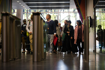 People entering auditorium hallway