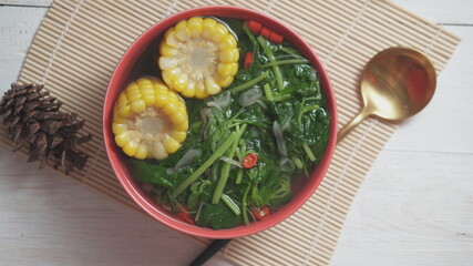 Known as Sayur bening bayam. Indonesian food of spinach with soup and corn