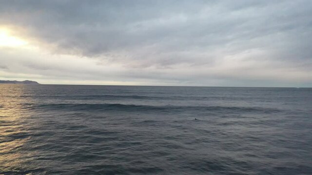 Surfer in scenic sundown, Alnes, Norway