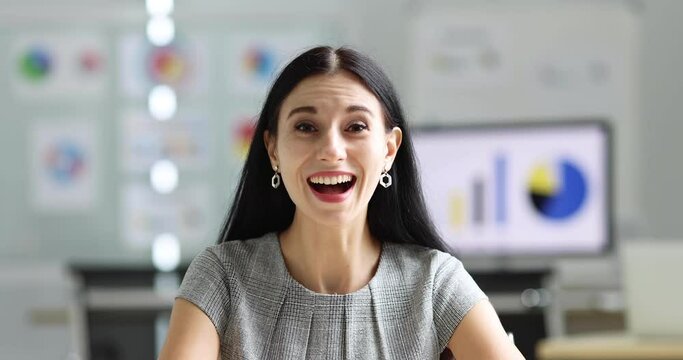 Confident executive adult caucasian businesswoman with beautiful friendly face sitting as online meeting attendee and laugh with happy and clear understanding. Good conference finished result idea.