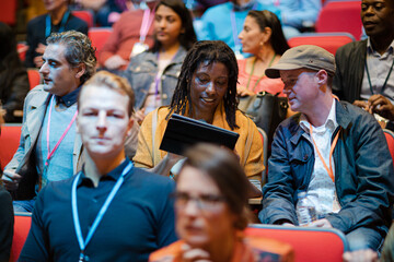 Business people talking in conference audience