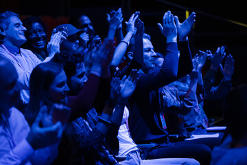 Enthusiastic audience clapping and cheering