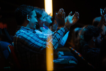 Enthusiastic audience clapping and cheering