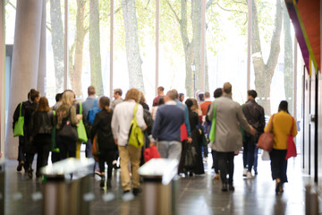 People leaving auditorium hallway