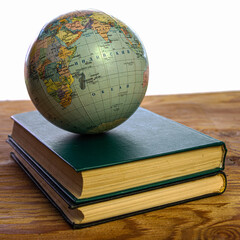 concept education school geographical globe on a stack of books