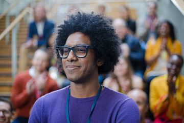 Male speaker smiling on stage
