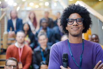 Male speaker smiling on stage