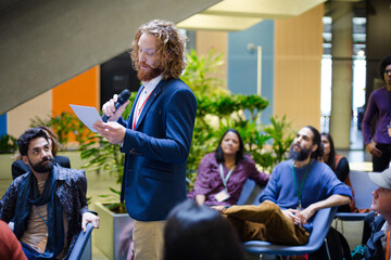 Male speaker on stage talking to audience