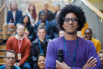 Male speaker smiling on stage