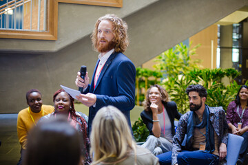 Male speaker on stage talking to audience
