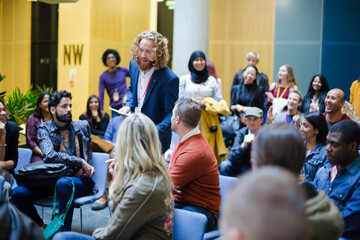 Male speaker on stage talking to audience