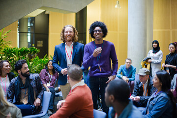 Audience watching speakers talking on stage