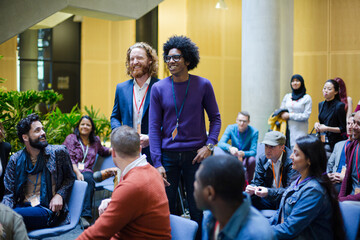 Audience watching speakers talking on stage