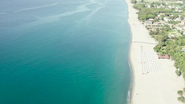 Aerial view of beautiful mediterranean sea and beach at sunny day, seascape and hill mountain on backgrond, Simeri Mare, Calabria, Southern Italy