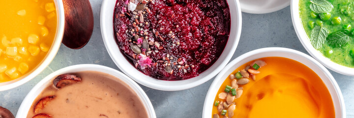 Healthy vegan cream soups panorama, vegetable detox banner, overhead flat lay shot of an assortment of dishes