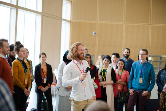 Male speaker with microphone talking on stage
