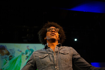 Male speaker on stage talking to audience