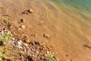 Beautiful sandy beach with rocks and clear turquoise water