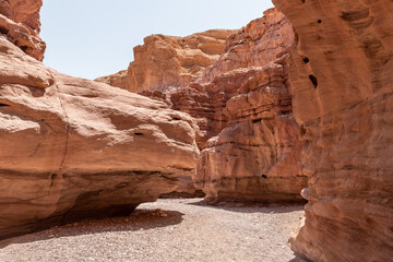 Narrow  passage between rocks in a nature reserve near Eilat city - Red Canyon, in southern Israel - obrazy, fototapety, plakaty