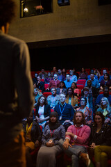 Male speaker on stage talking to audience