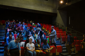 Audience entering dark auditorium