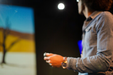 Male speaker on stage talking to audience