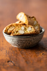 Italian cantuccini cookies in bowl. Sweet dried biscuits with almonds.