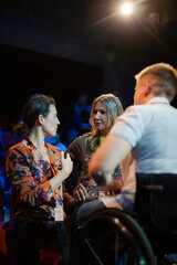 Audience talking to speaker in wheelchairs on stage