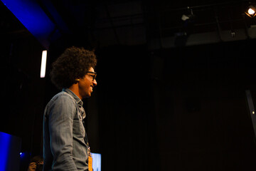 Male speaker on stage talking to audience