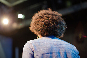 Male speaker on stage talking to audience