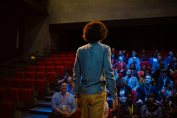 Fototapeta na wymiar Male speaker on stage talking to audience