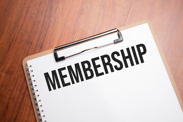 Membership text on white paper on the wood table