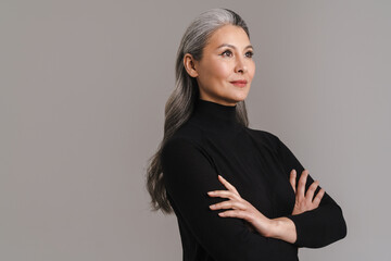 Mature asian white-haired woman posing with her arms crossed