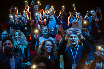 Smiling, excited audience cheering